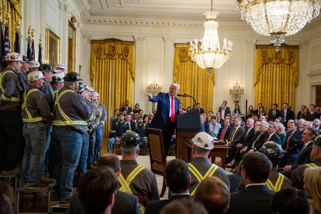 US President Donald Trump speaks next to coal industry workers, on the day he signs energy-related executive orders at the White House.